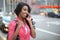 Black African American woman talking cellphone in city