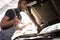 Black african auto mechanic does not understand how to troubleshoot the machine