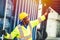 Black African worker working in logistic shipping radio control order command loading containers at shipping port. staff cargo for