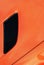 Black air intake grid of orange sport turbo car