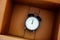 Black alarm clock inside a box