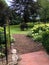 Black archway in flower garden