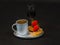 black aromatic coffee with two croissants decorated with strawberry, liqueur in a glass