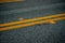 Black asphalt road with yellow lines and orange reflectors