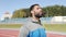 Black athlete with a beard in a sports suit goes outdoors.