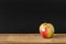 black background apple wooden table