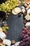 Black background with cheeses, grapes, crackers and wine