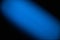 On a black background wide diagonal blurred textural beam of blue color