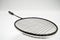 Black badminton racquet on a white background