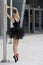Black ballerina near pole