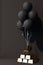 Black balloon Tied up with a gold bar