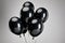 Of black balloons isolated on grey