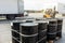 Black barrels with oil. Warehousing containers ready for shipment. Refining and selling oil derivatives