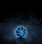 black basketball with bright blue glowing neon lines on black background with smoke