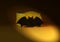A black bat on yellow background. Black bat using on halloween party or decoration for your lands