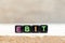 Black bead with letter in word EBIT Abbreviation of Earnings Before Interest and Taxes on wood background