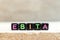 Black bead with letter in word EBITA abbreviation of  earnings before interest, taxes and amortization on wood background