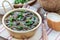 Black bean and ham soup in aluminum bowl on wooden table, horizontal