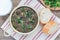 Black bean and ham soup in aluminum bowl on wooden table, horizontal, top view