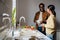 Black bearded man smiling while making sandwiches with his daughter