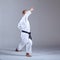With a black belt, the athlete trains the block with his hand in a formal karate exercise