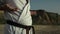 Black belt fighter training hands exercises practicing karate ion beach closeup.