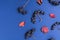 Black berries and autumn leaves on a dark blue background. Top view. Clusters of berries. Pastel embossed paper. Autumn compositio