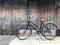 Black bike brown cushion The front door of the house and the old wooden wall is not painted with a simple life concept, exercise,