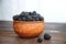 Black blackberries in clay ware on a table