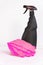 Black blank plastic spray detergent bottle and pink rubber gloves  on white background. Household chemicals. Cleaning product