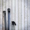 Black blank skis on wooden planks wall, winter background