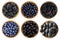 Black and blue berries on a white background. Blackberries, blackcurrants, blueberries, mulberries and grapes in a wooden bowl.