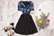 Black with blue sequins dress, shoes and spruce branch on a wood