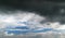 Black- blue sky with a large storm cloud