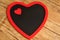 Black board heart decorated with a red heart