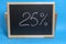 Black Board in a wooden frame on a blue background with the inscription 25 percent. Mockup for shopping, sales