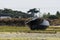 Black boat grounded at low tide