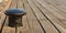 Black bollard mooring on wooden deck background. Closeup view with details, Copy space