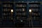 A black bookcase in a dark room and dim light.