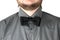 Black bow-tie with gray shirt on men\'s neck.