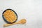 Black bowl chickpeas with wood spoon white copy space background, top view flat lay