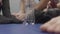 Black boxing gloves, peoples legs and bottle of water on the floor