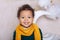 Black boy close up Portrait . Portrait of a cheerful smiling boy in a yellow scarf. The baby is smiling. Little African American.