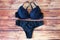 Black bras and panties on wooden background