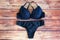 Black bras and panties on wooden background