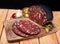 Black brawn, blood sausage, black pudding on a wood cutting board, close up. Polish cold cuts, meat products.