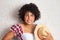 Black brazilian woman with curly hair holding straw hat dressed with typical plaid shirt. Festa Junina in Brazil,