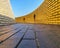 Black brick path with yellow brick wall leads to the top of the lookout tower called Ziggurat