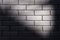 Black brick wall with sunbeam texture background. Beautiful new dark bricks with natural vignette