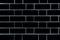 Black brick wall. Vector graphics. Background image of a brick wall.